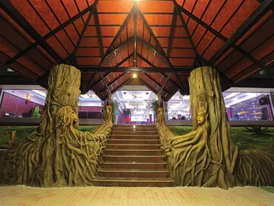 a room with a staircase with trees and a building at Coorg Cliffs Resorts in Ammatti