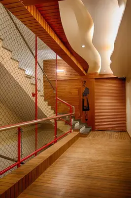 a staircase in a building with red metal railing at The Cocoon in Gonikoppal