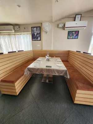 a dining room with a table in the middle at The Cocoon in Gonikoppal