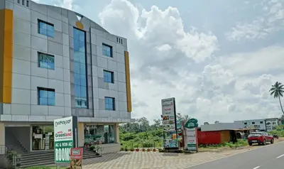 a building on the side of a street at Treebo Green Land Coorg in Kushālnagar
