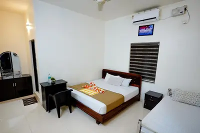 a bedroom with a bed and a tv in a room at Athirappilly Ambady Resort in Athirappilly