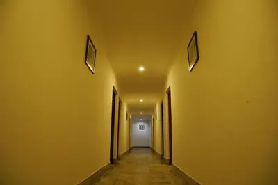 a hallway with yellow walls and a white door at Kairali Tourist Home in Guruvāyūr