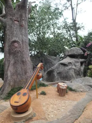 a guitar on a stand next to a tree at Wayanad Royal Stream in Kalpetta