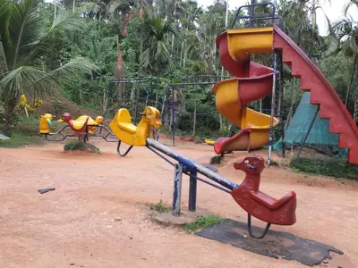 a playground with a slide and a play equipment at Wayanad Royal Stream in Kalpetta
