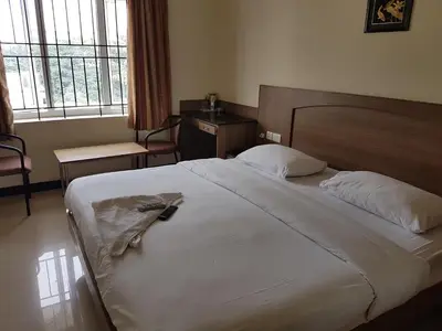 a bedroom with a bed with a robe on it at SK Residency in Coimbatore