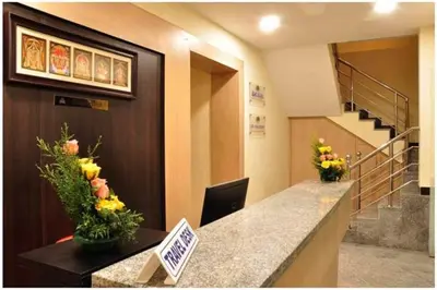 a lobby with a reception desk with flowers on it at SK Residency Unit 2 in Coimbatore