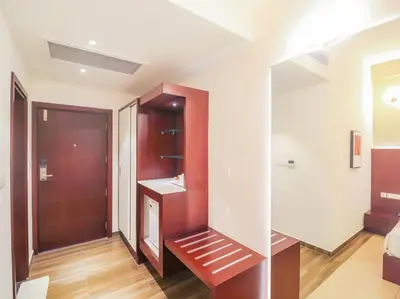 a room with a hallway with a door and a mirror at Samudra Mysore in Mysore