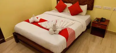 a bedroom with two beds with stuffed animals on them at Hotel Green Plaza in Trichūr