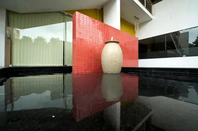 a vase sitting on the floor of a building at President Hotel in Mysore