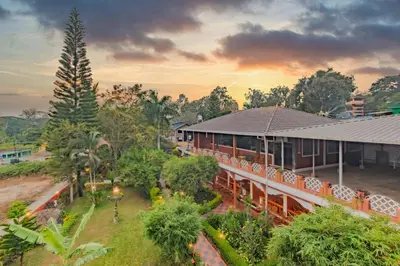 an overhead view of a building with trees and a street at The Nest Inn Resort in Masinagudi