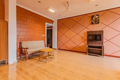 a living room with a couch a table and a television at The Nest Inn Resort in Masinagudi