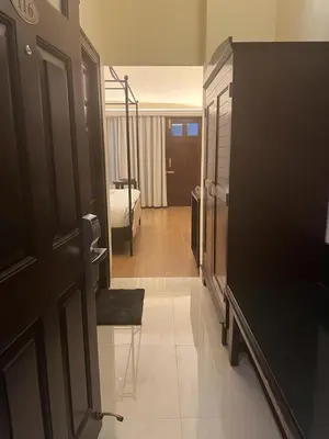a hallway of a hotel room with a bedroom at Royal Orchid Metropole Mysore in Mysore