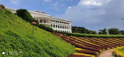a large building with a garden in front of it at Royal Orchid Brindavan Garden Palace & Spa Mysore in Belagula