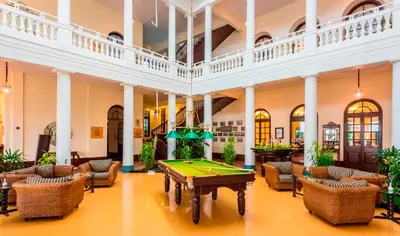 a pool table in the middle of a room with couches at Royal Orchid Brindavan Garden Palace & Spa Mysore in Belagula