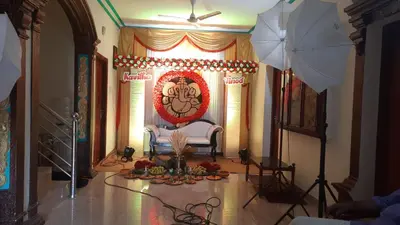 a living room with a chair and an umbrella at Krishnendu Homestay outer ring road north nada guruvayur in Guruvāyūr