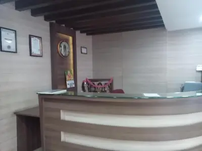 a waiting room with a counter and a chair at Hotel Preethi Palace in Ooty