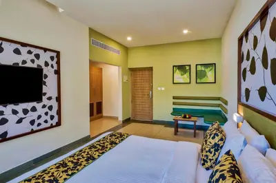 a living room with a couch and a tv at Sterling Wayanad in Sultan Bathery