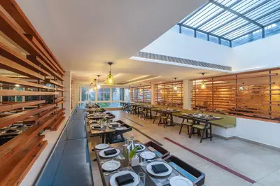 a large dining room with tables and chairs at Sterling Wayanad in Sultan Bathery