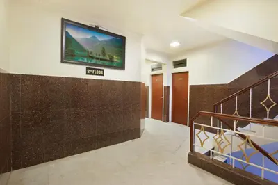 a hallway with a flat screen tv on a wall at Mannars Yatri Nivas Hotel in Mysore