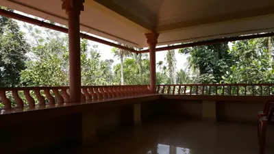 a balcony of a house with trees in the background at Wayanad Homestay in Kalpetta