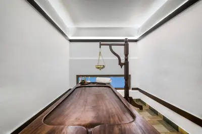a large wooden table in a room with a ceiling at Elixir Hills Suites Resort and Spa in Munnar