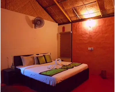 a bedroom with a bed in a room at KOOMANKOLLY RESORT in Thirunelli