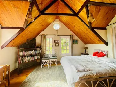 a bedroom with a large bed and wooden ceilings at Stumpfields in Ooty