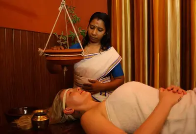 a woman laying on the floor in a room with a scale at Namasthe Ayurveda and Yoga Retreat Cochin Only for Ayurveda and Yoga Wellness Stay in Nedumbassery