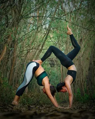 two women are doing yoga in the woods at Namasthe Ayurveda and Yoga Retreat Cochin Only for Ayurveda and Yoga Wellness Stay in Nedumbassery