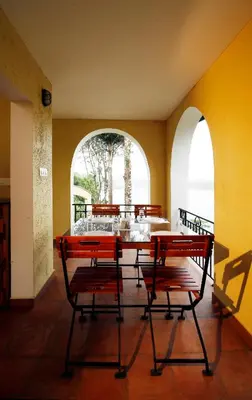 a dining room with a table and two chairs at Vista Del Lago in Ambalavayal