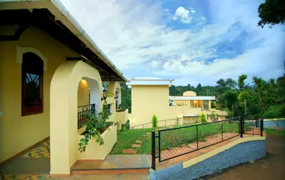 a house with a balcony and a fence at Vista Del Lago in Ambalavayal