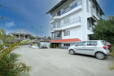a car parked in front of a white building at Kurinji Wanderlust Resort Munnar in Munnar
