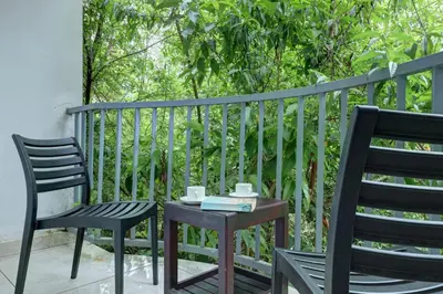 two chairs and a table on a balcony at Kurinji Wanderlust Resort Munnar in Munnar
