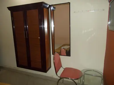 a chair sitting in front of a mirror at Avanti Inn in Guruvāyūr