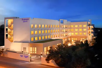 a large white building with lights on at Fairfield by Marriott Coimbatore in Coimbatore