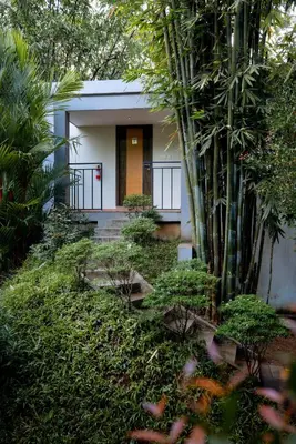 a small house with a bunch of plants in front of it at Casa Rio Resorts Athirappilly in Athirappilly