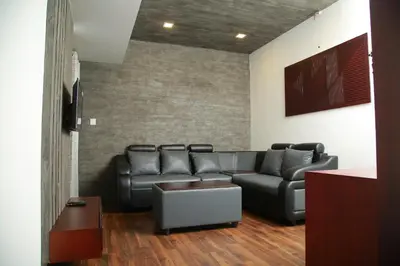a living room with a couch and a tv at Four N Square Residency in Palakkad