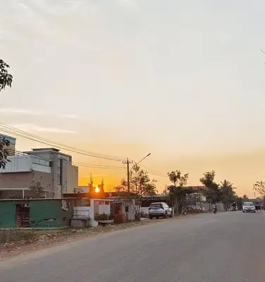 a street with cars parked on the side of the road at Sugamya Corner Guesthouse in Mysore