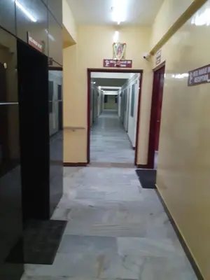a hallway in a building with at Hotel Paradise Inn in Tiruppūr