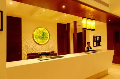 a man sitting at a counter in a restaurant at Lemon Tree Hotel Coimbatore in Coimbatore