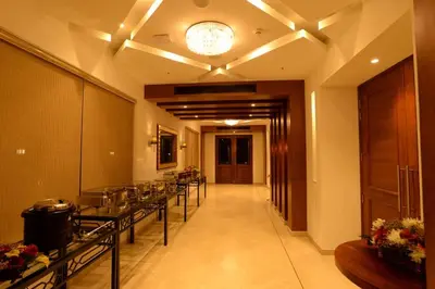 a hallway with a row of tables in a building at Lemon Tree Hotel Coimbatore in Coimbatore