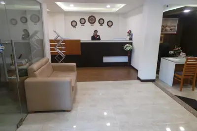 a woman is standing at the counter of a salon at SAAS Residency in Kozhikode