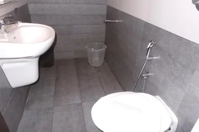 a bathroom with a toilet and a sink at SAAS Residency in Kozhikode