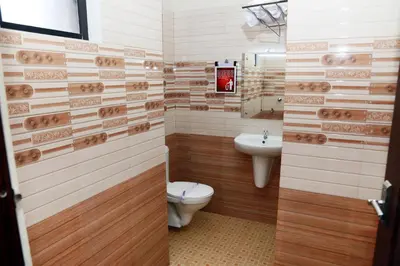 a bathroom with a toilet and a sink at Anandkrishna Residency in Guruvāyūr