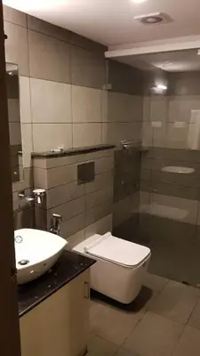 a bathroom with a toilet and a sink at U C plaza in Perintalmanna