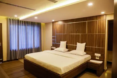 a bedroom with a large bed and a large window at U C plaza in Perintalmanna
