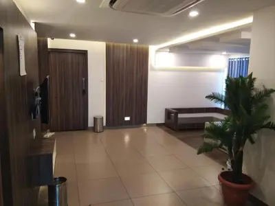a hallway with a couch and a plant in a building at U C plaza in Perintalmanna