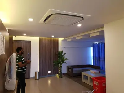 a man is standing in a living room at U C plaza in Perintalmanna