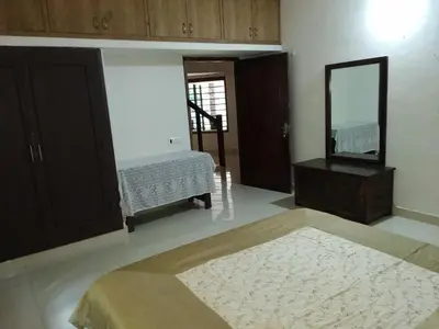 a living room with a mirror and a sink at Kwality Estate in Madikeri