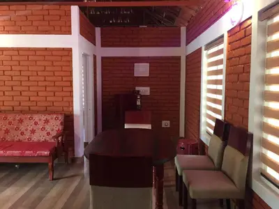a dining room with a table and chairs at Marsim Holiday Resort in Vythiri